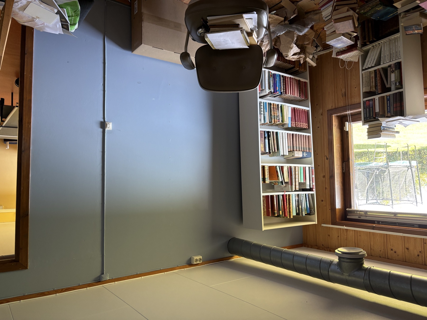Target wall with the existing tall white bookshelf on the left, light switch and doorway