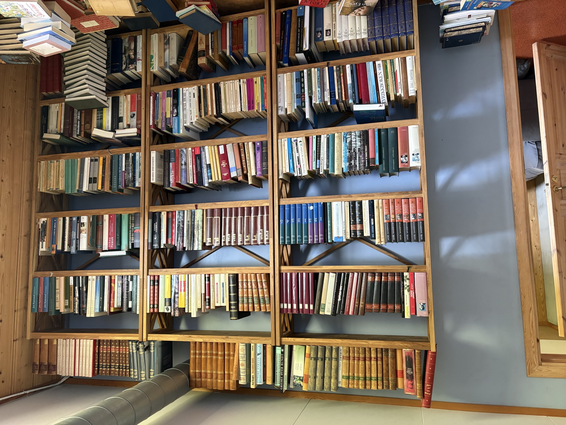 Three existing open wooden bookcases with diagonal bracing
